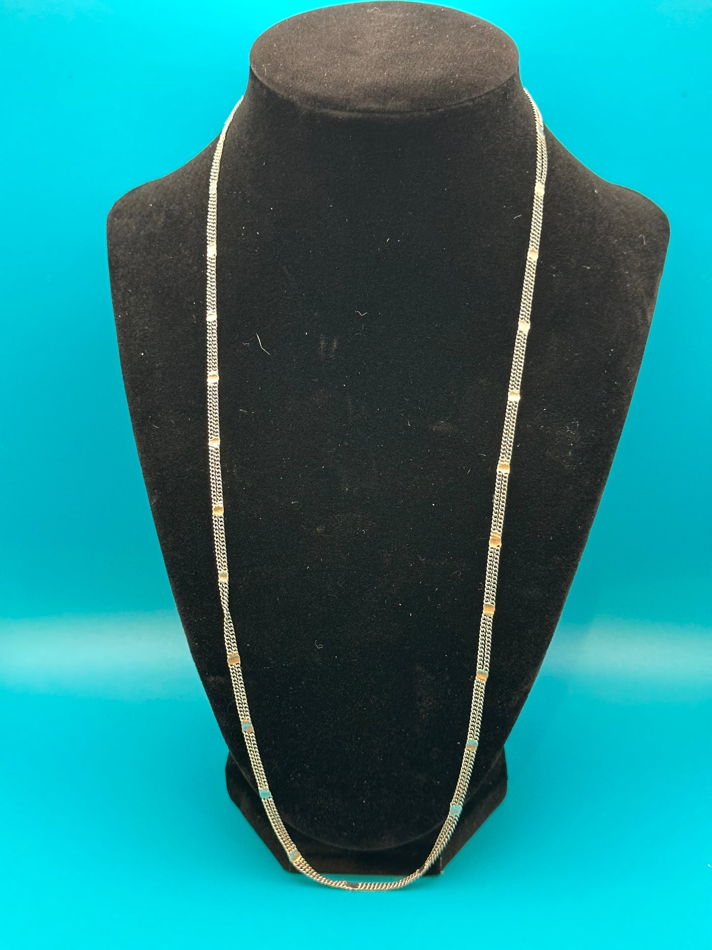 Attractive, light and airy fashion chain-link necklace. Three strands. It looks like sterling, but is unmarked.