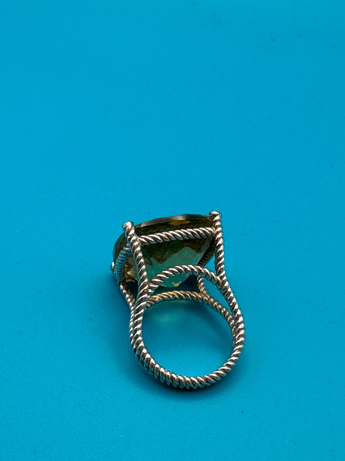 Lemon quartz cushion-cut stone in a sterling silver ring in rope setting