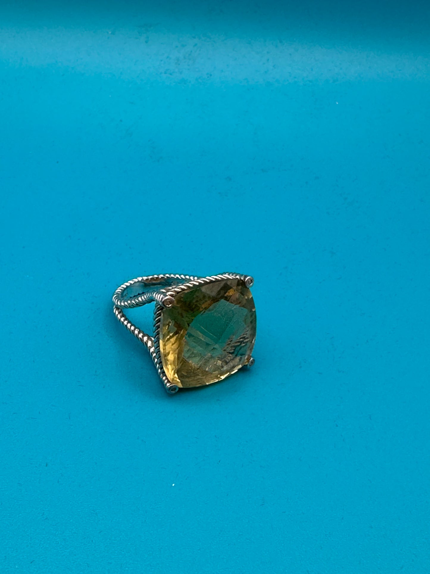Lemon quartz cushion-cut stone in a sterling silver ring in rope setting