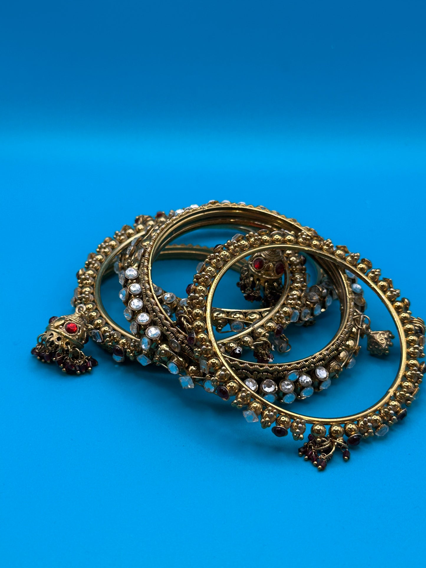 Six Indian bangle bracelets with a variety of stones and styles