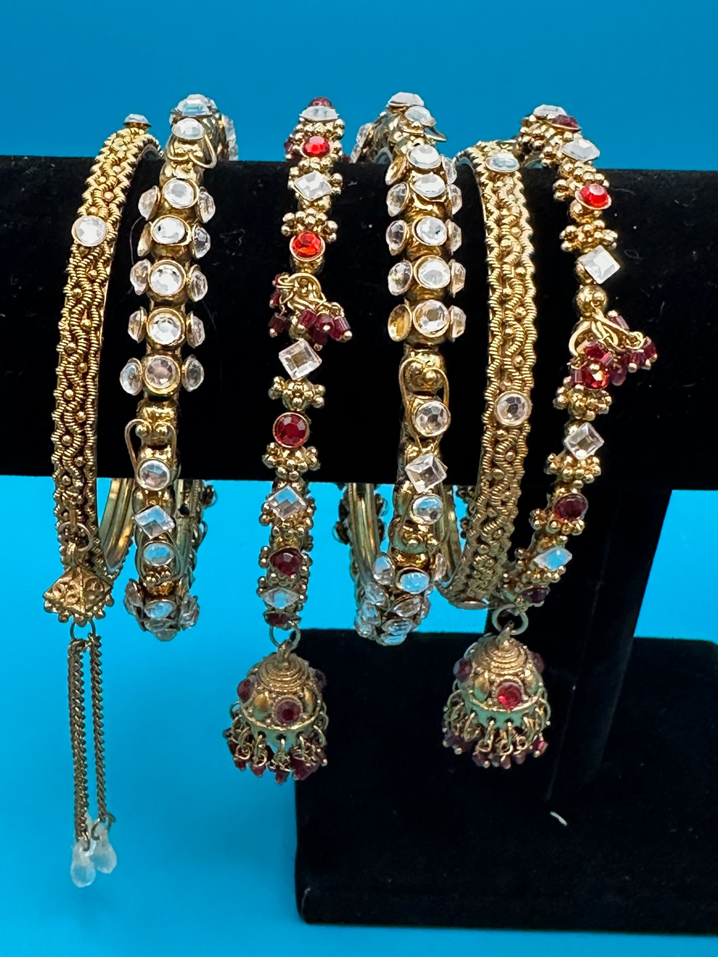Six Indian bangle bracelets with a variety of stones and styles