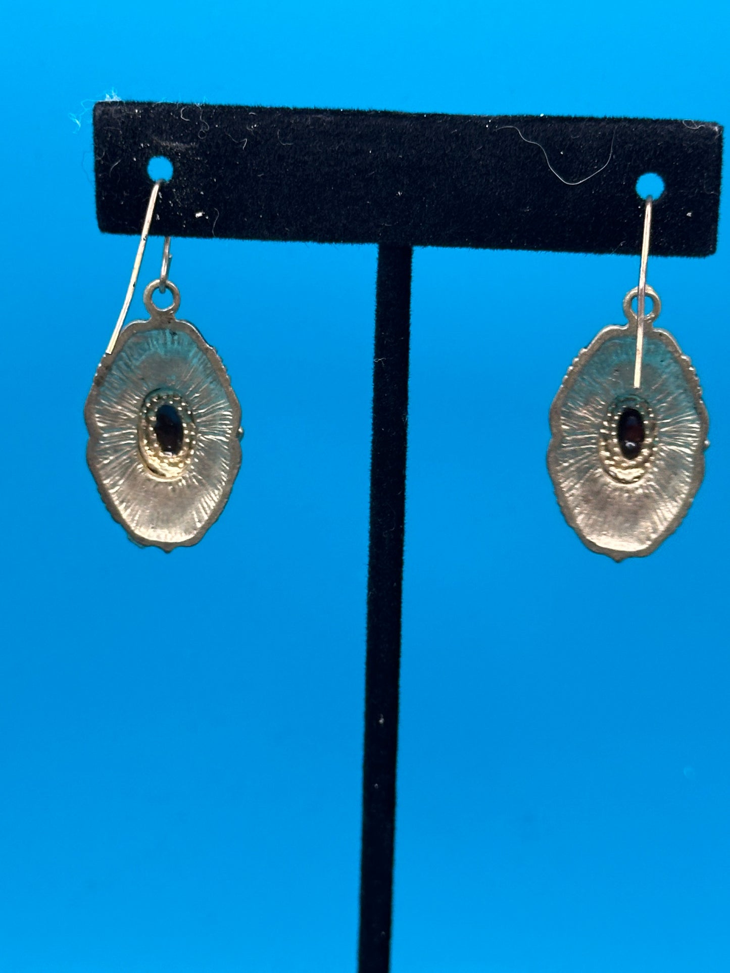 Carnelian-like stone and gold metal drop earrings on an ear wire