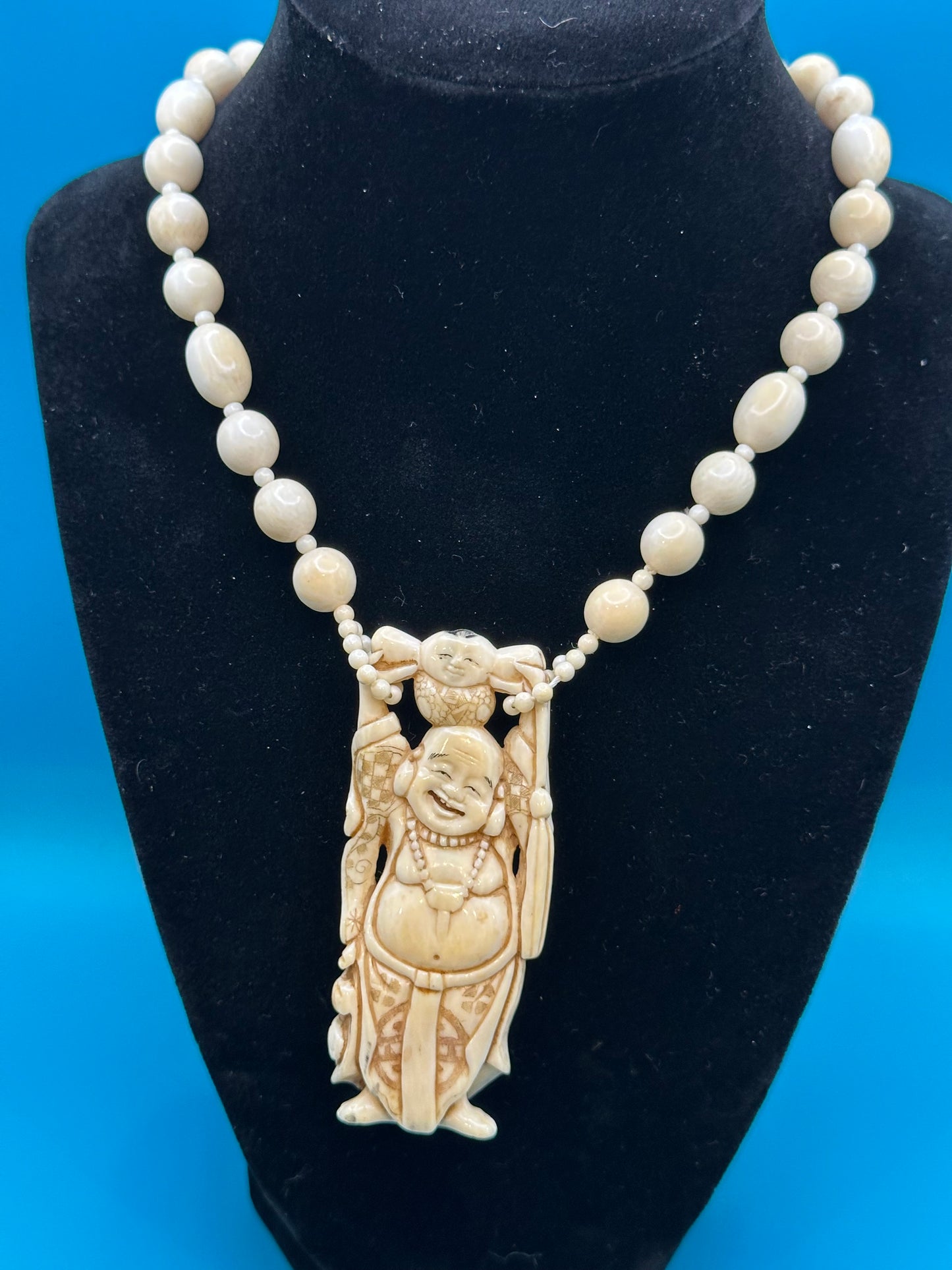 Authentic ivory necklace with carved and colored buddha charm