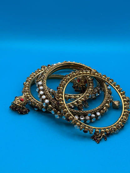Six Indian bangle bracelets with a variety of stones and styles