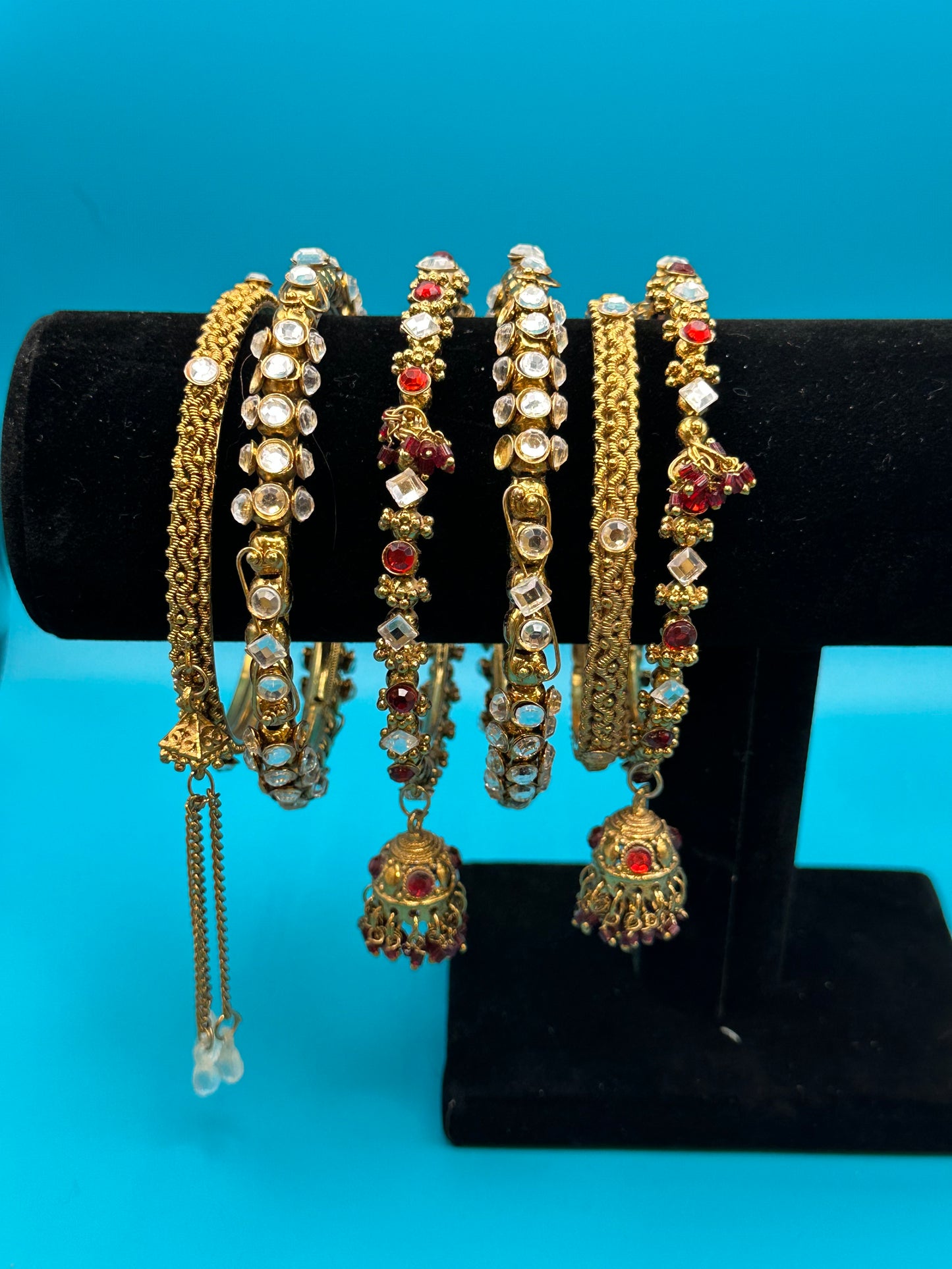 Six Indian bangle bracelets with a variety of stones and styles