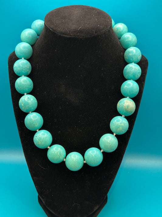 Vintage turquoise choker necklace. There are knots between each bead. Very large beads with silver metal clasp. Excellent condition