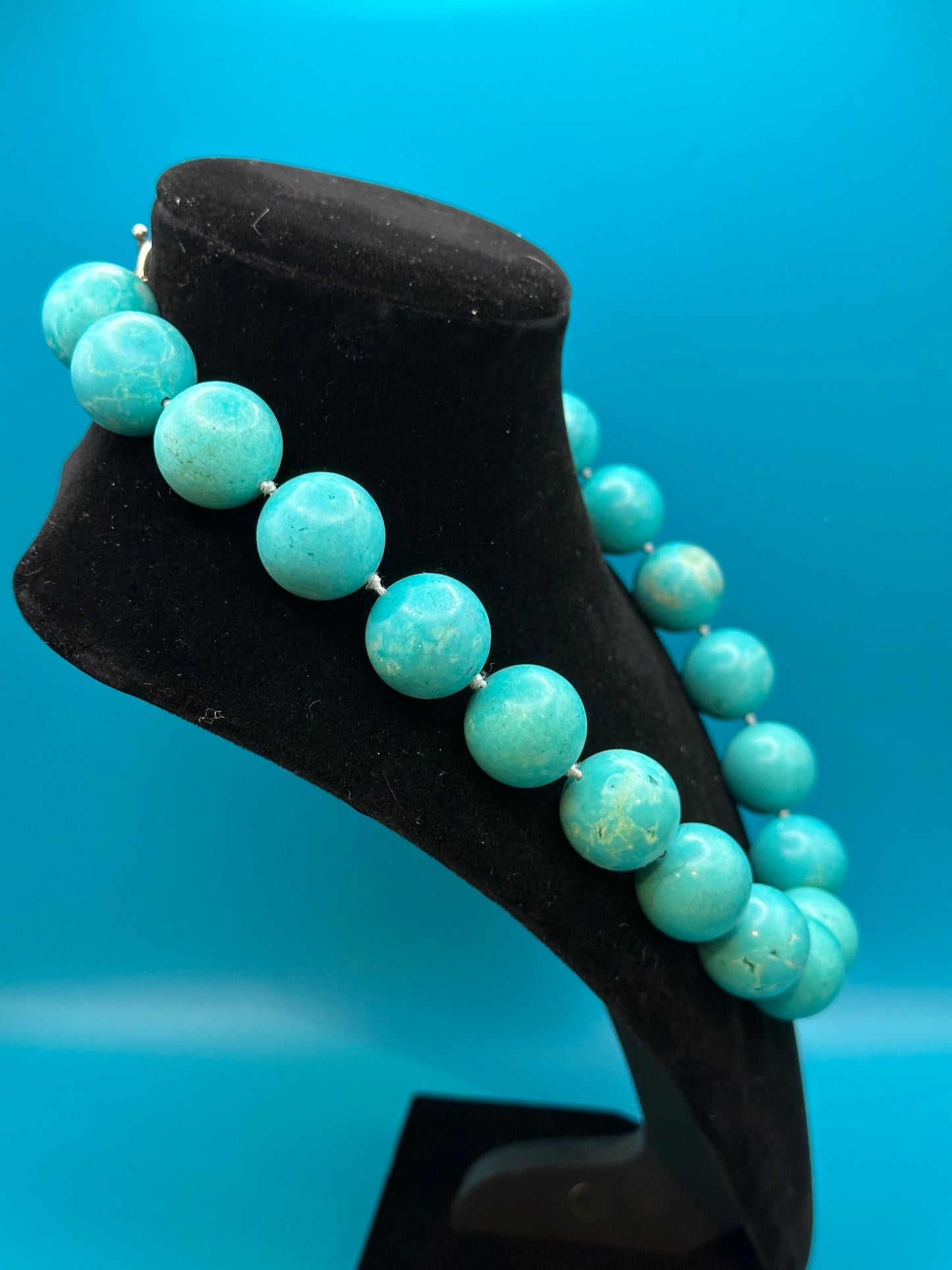 Vintage turquoise choker necklace. There are knots between each bead. Very large beads with silver metal clasp. Excellent condition