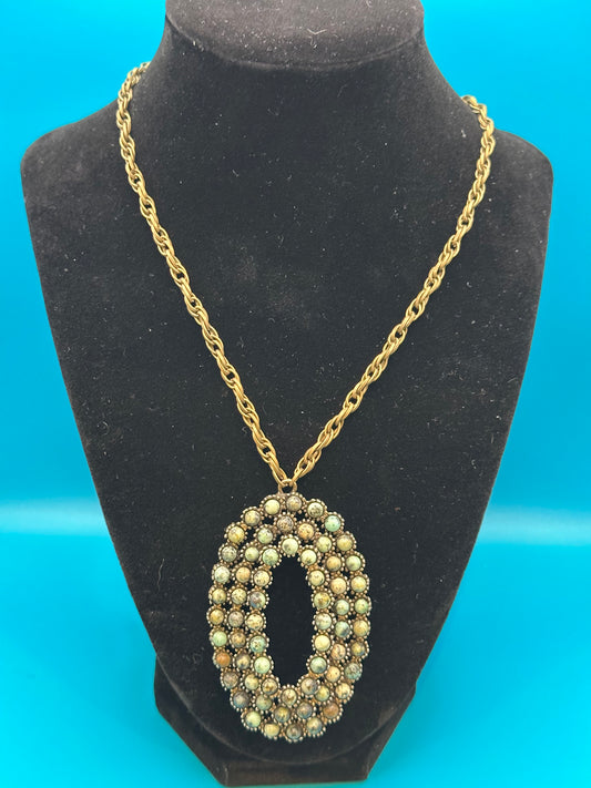 Oval stone pendant on gold chain