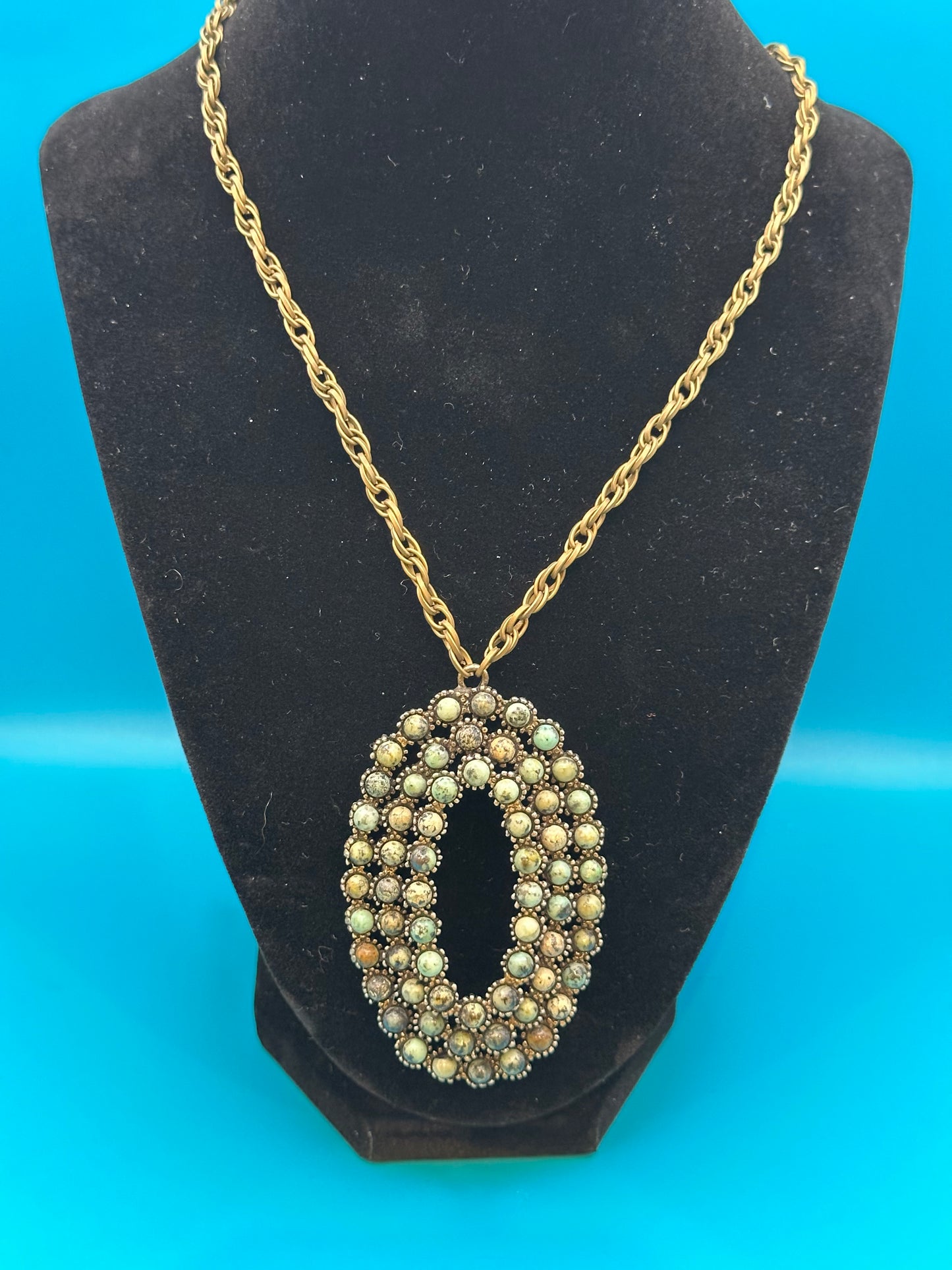 Oval stone pendant on gold chain