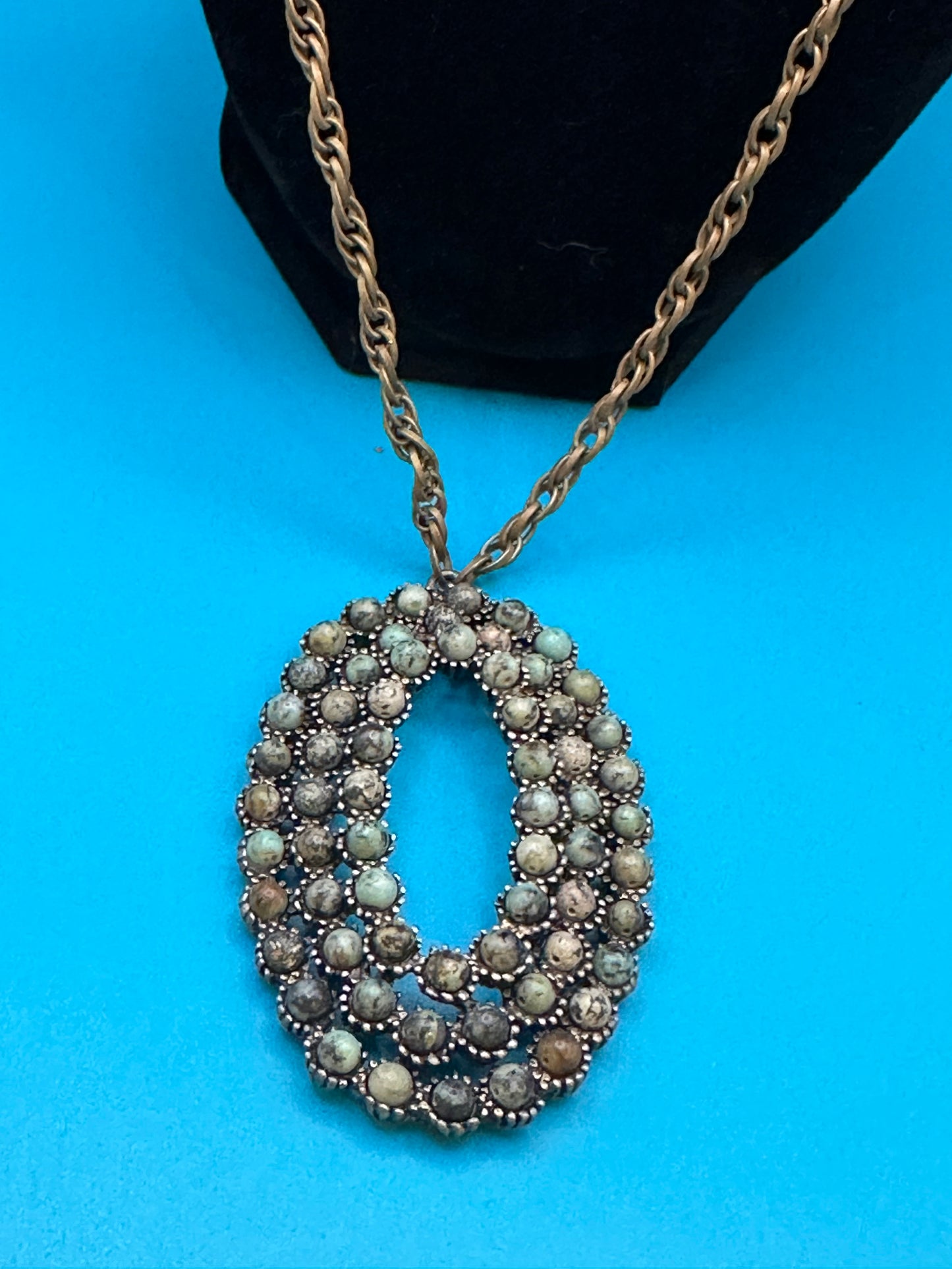 Oval stone pendant on gold chain