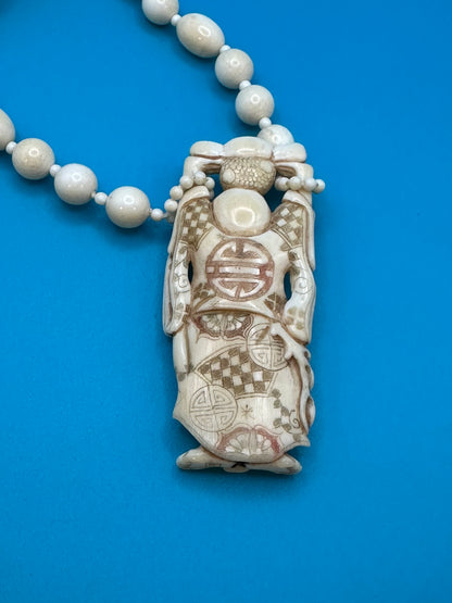 Authentic ivory necklace with carved and colored buddha charm